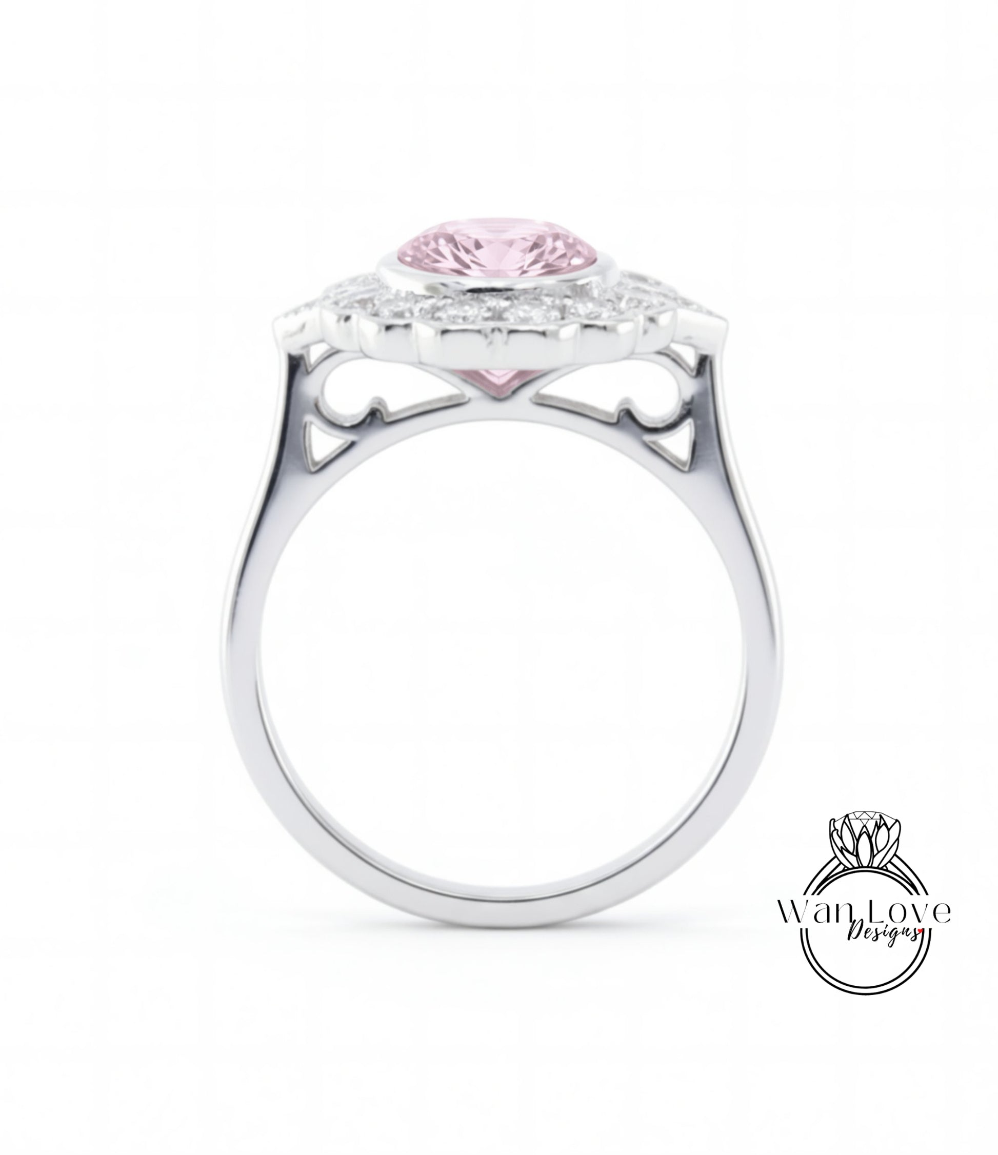A silver ring with a large pink gemstone, possibly a diamond, set in the center.