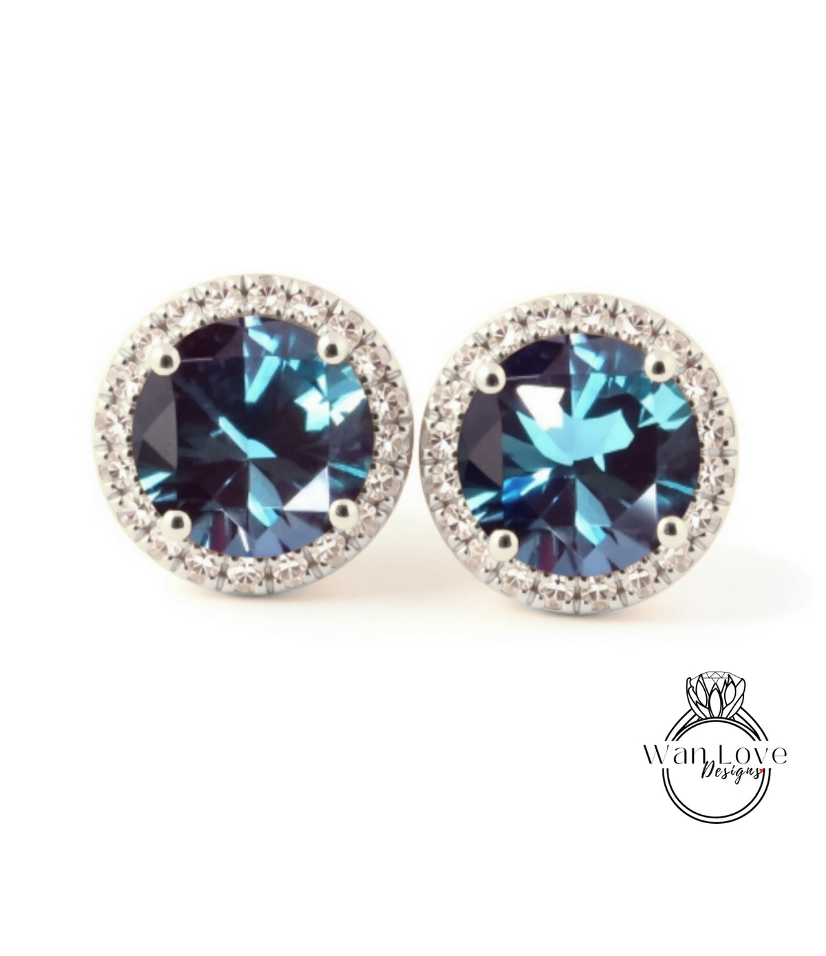 A pair of earrings with blue gemstones set in a halo of small diamonds.