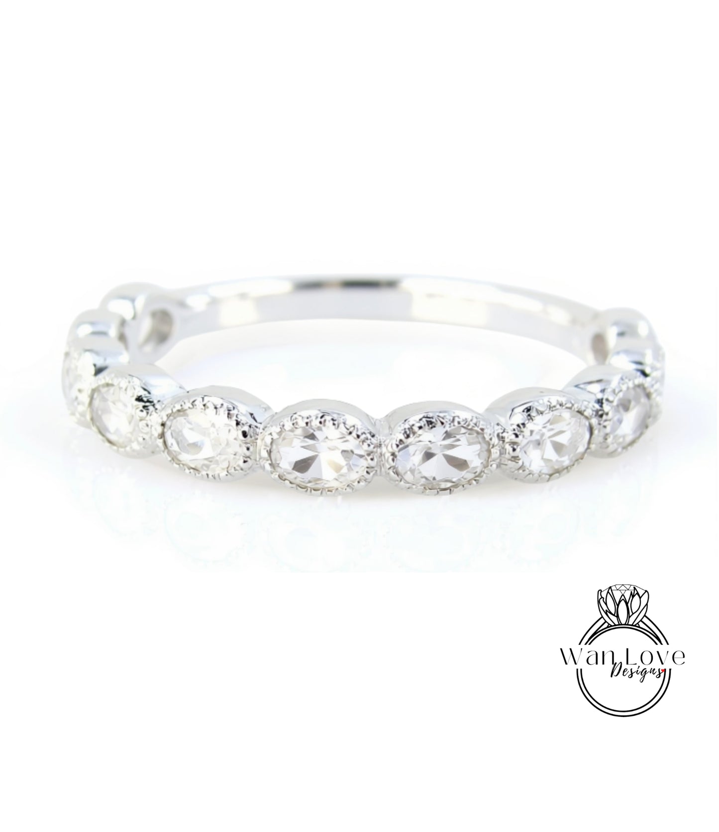 A silver ring with a row of round diamonds set in a band.