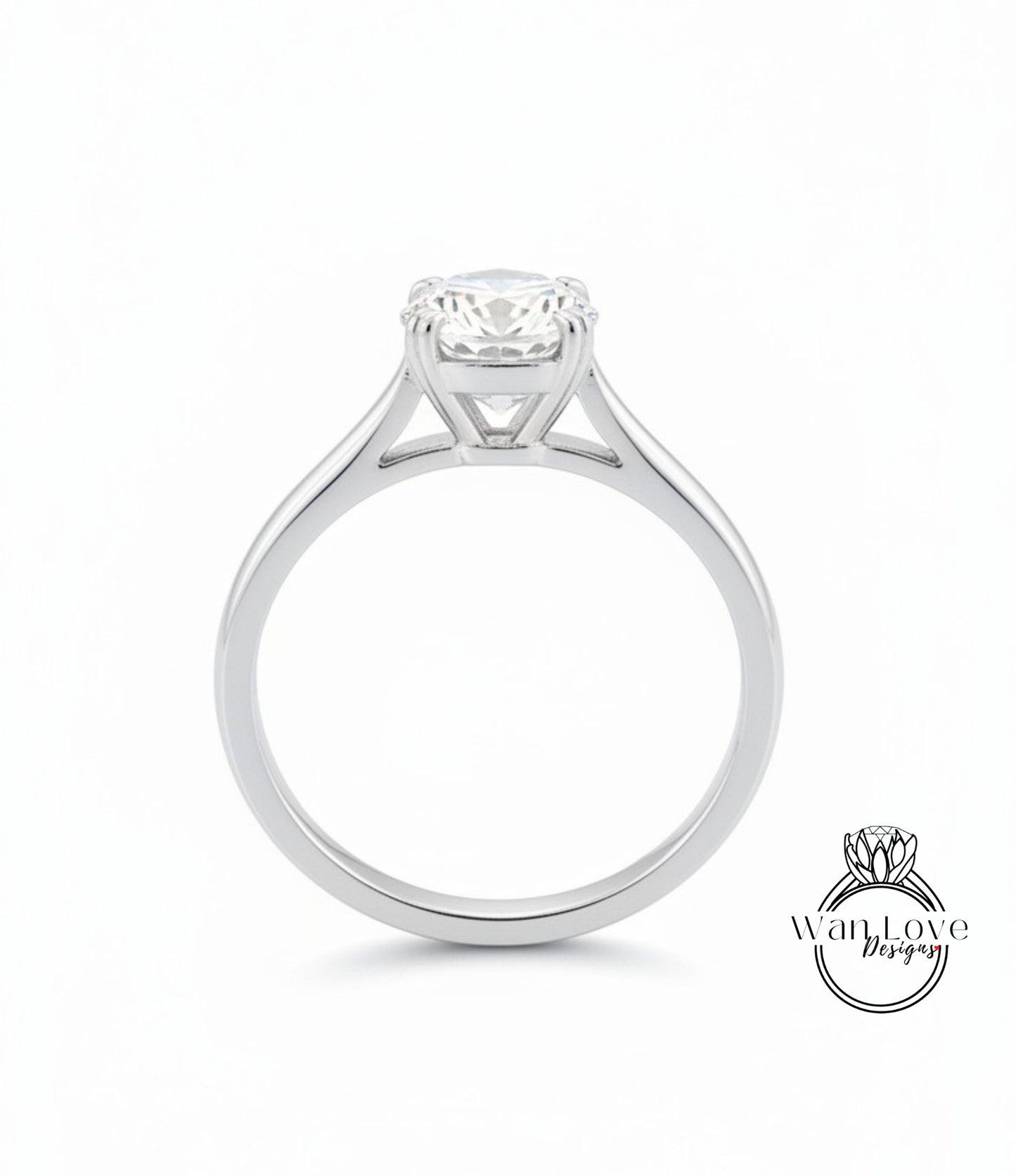 A silver engagement ring with a large central diamond set in a pavé style, showcasing the intricate design and craftsmanship of the piece.
