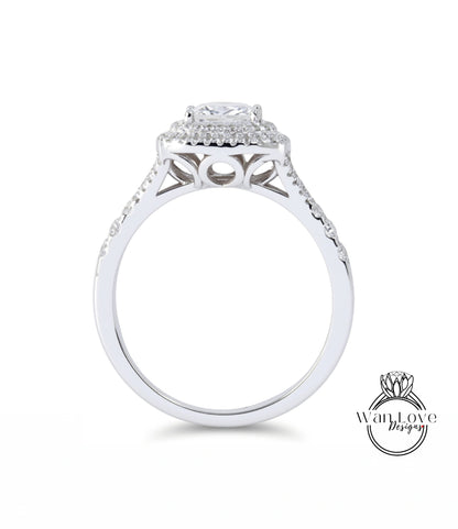 A silver engagement ring with a large central diamond surrounded by smaller diamonds, set in a halo of smaller diamonds.