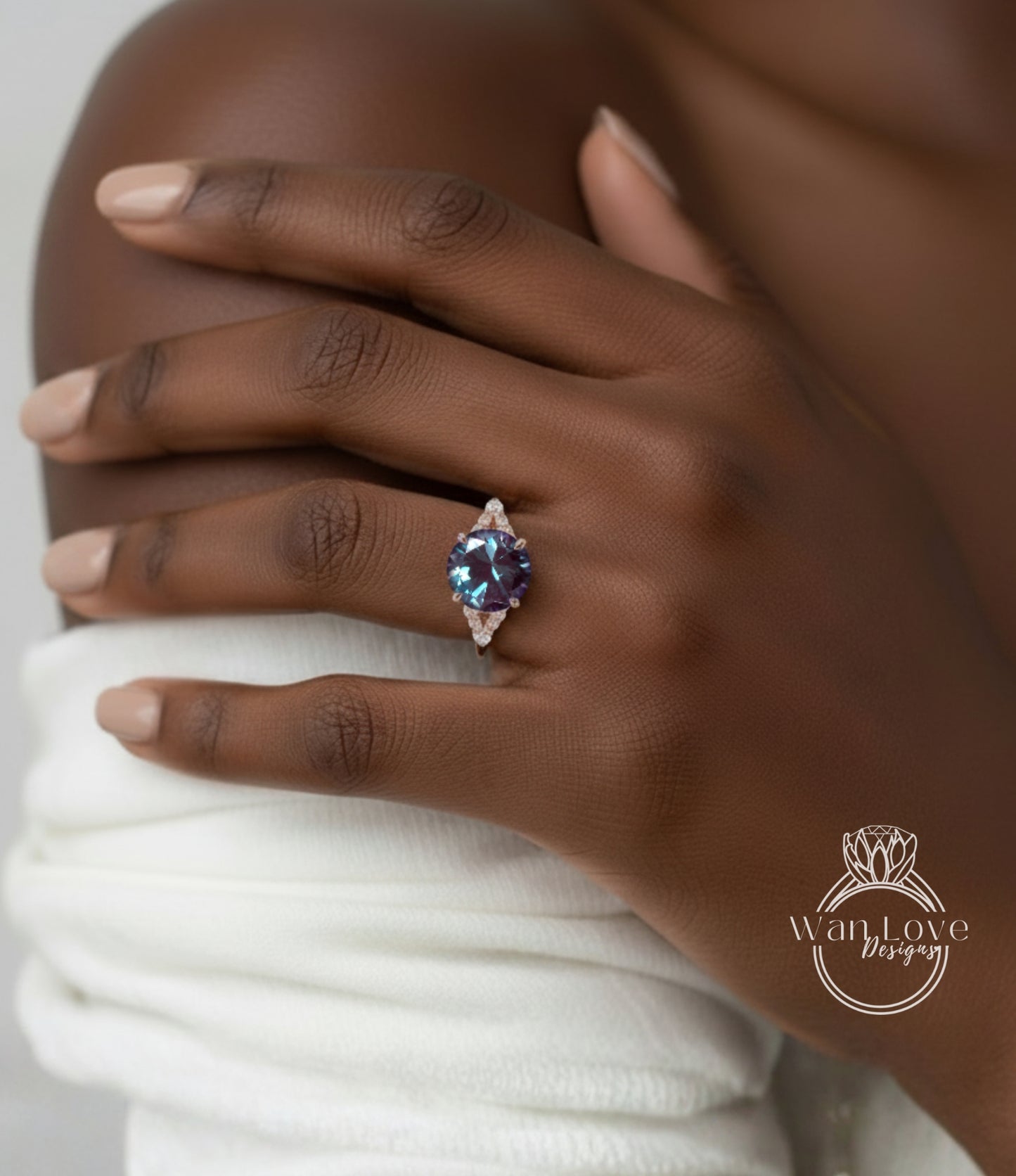 A close-up of a person's hand wearing a ring with a large, blue gemstone.