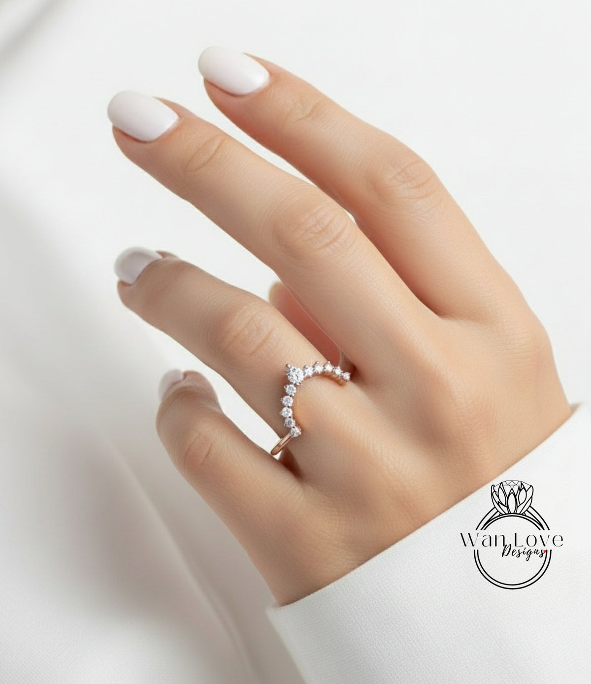 A close-up of a hand wearing a gold ring with a diamond-encrusted band, against a white background.