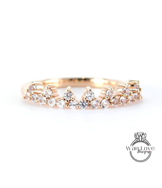 A gold ring with a decorative band featuring small diamonds.