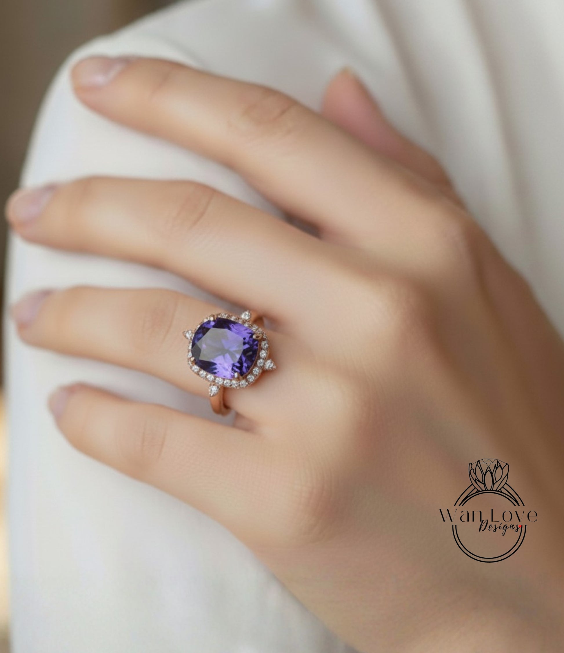 A close-up of a person's hand wearing a large, ornate ring with a purple gemstone.