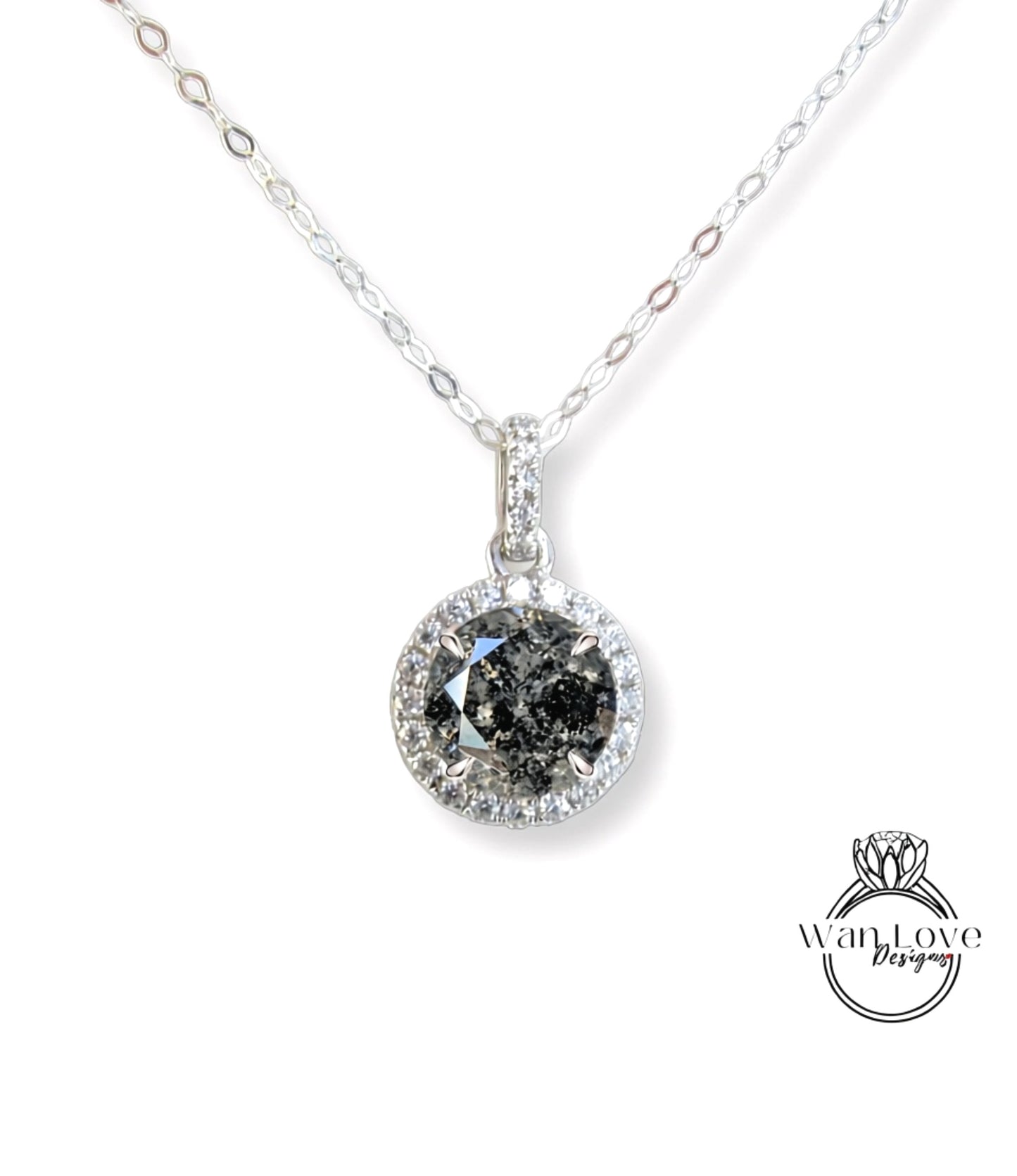 A silver necklace with a large, round diamond pendant.
