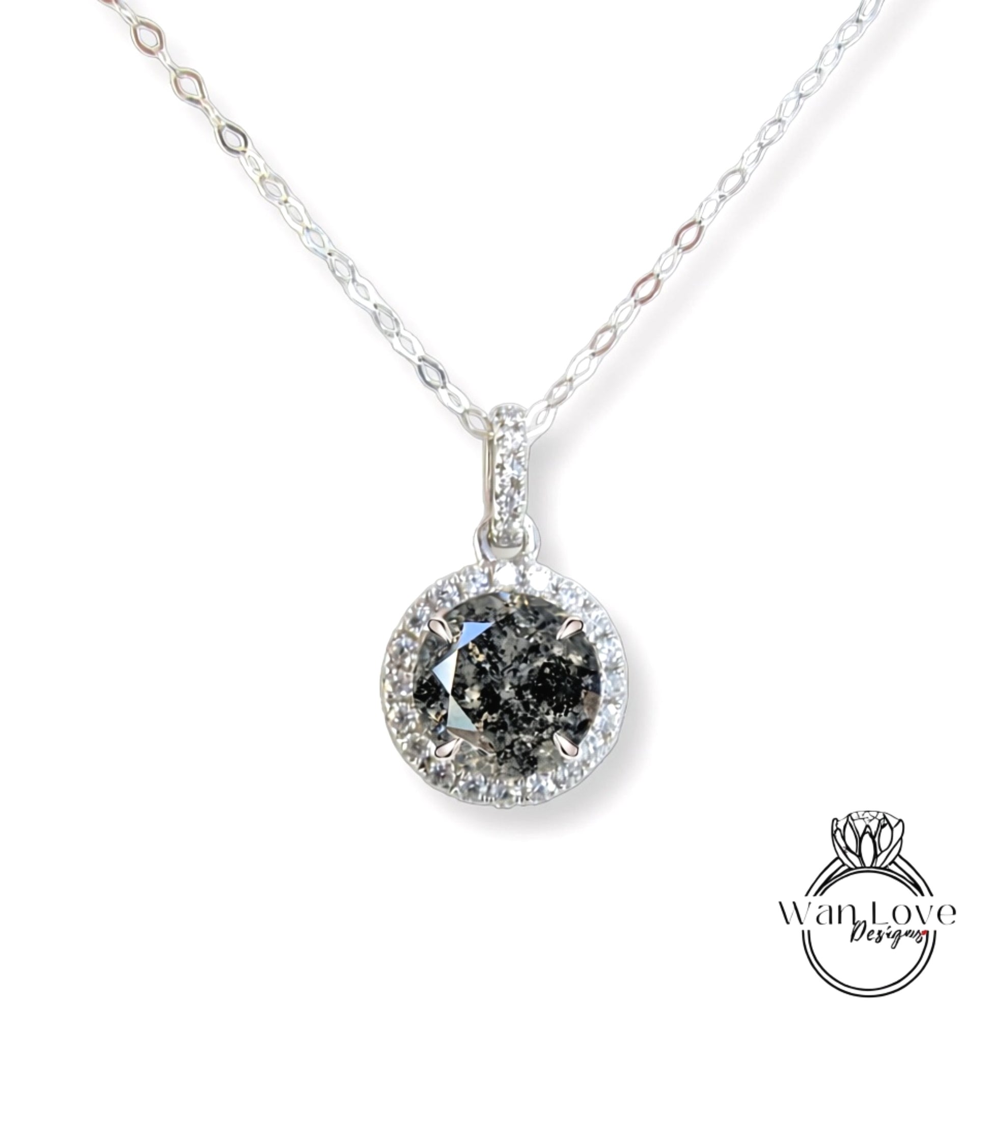 A silver necklace with a large, round diamond pendant.