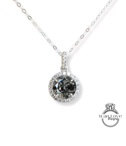 A silver necklace with a large, round diamond pendant.