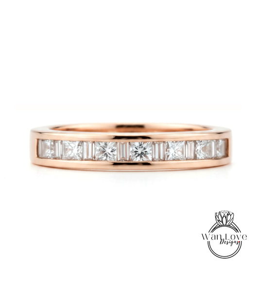 A rose gold band with a row of clear diamonds set in it.