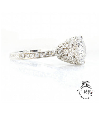 A close-up view of a diamond engagement ring with a large central diamond surrounded by smaller diamonds set in a silver band.