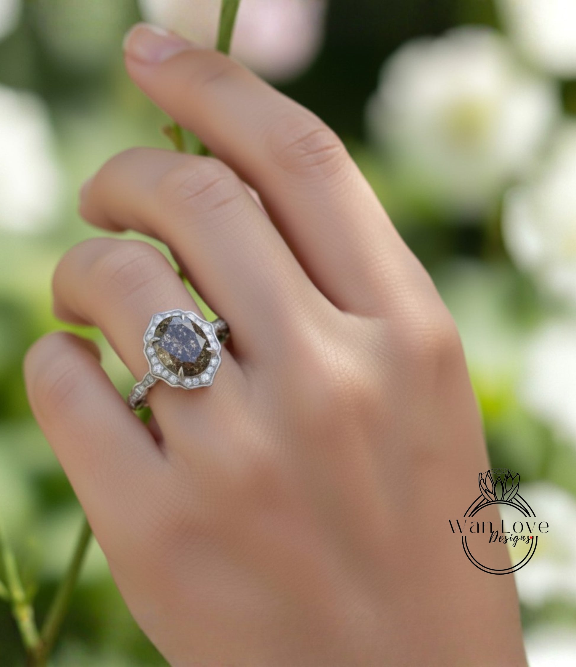 A close-up of a hand wearing a diamond ring with a large oval-shaped gemstone.