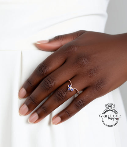 A close-up of a hand wearing a ring with a heart-shaped design.