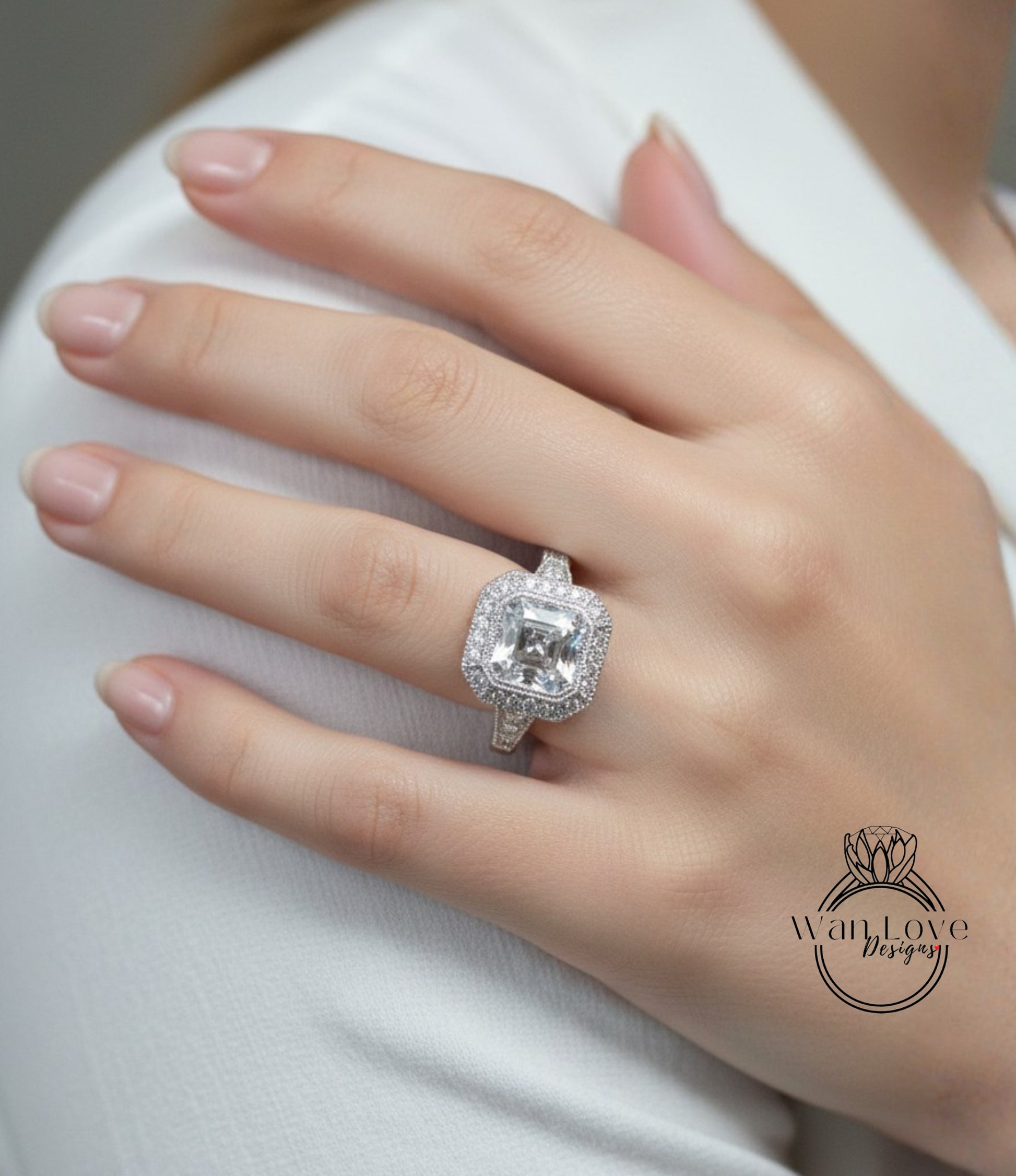 A close-up of a person's hand wearing a large, sparkling diamond ring on the ring finger.