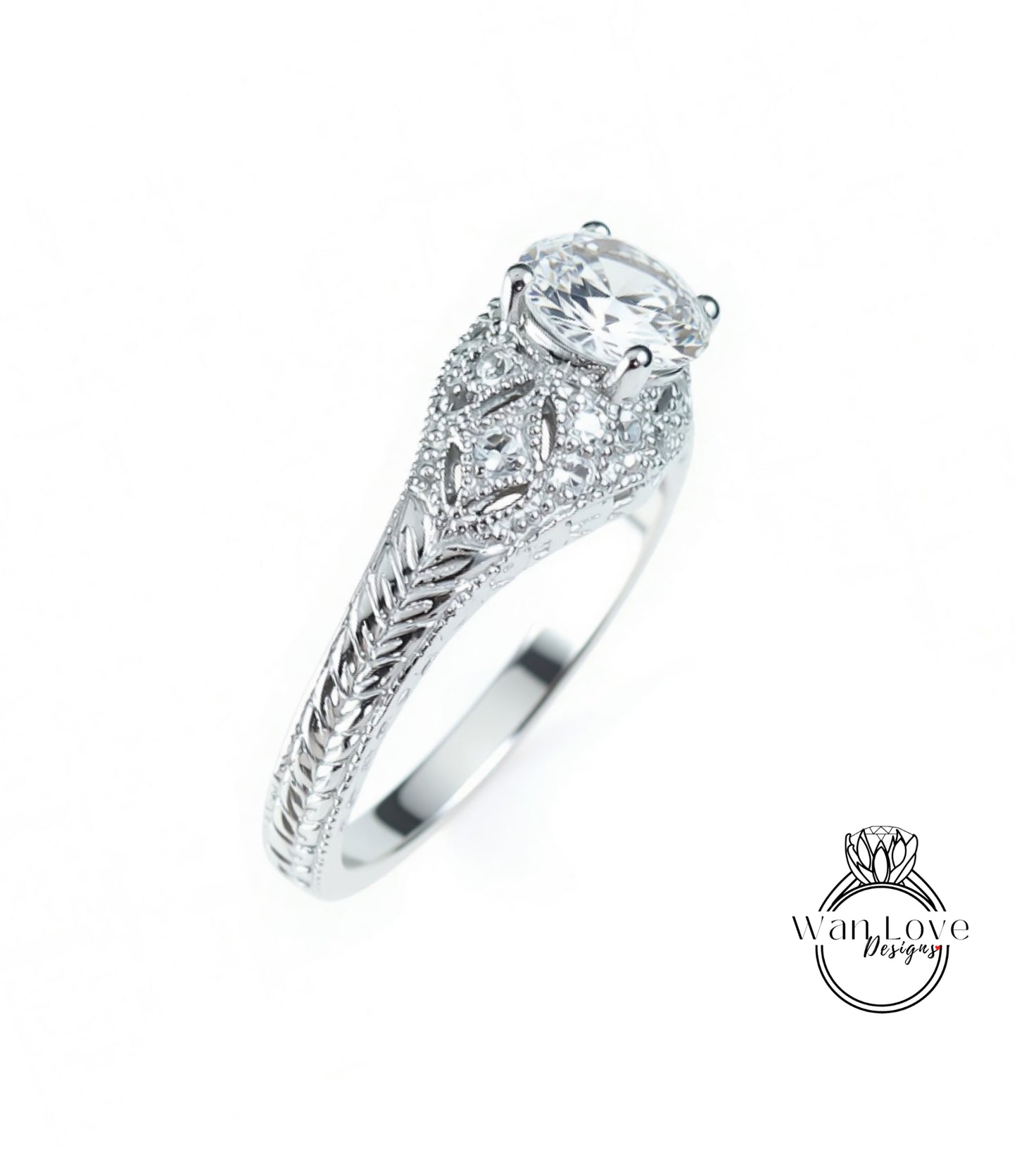 A close-up view of a silver engagement ring with a large central diamond surrounded by smaller diamonds and intricate metalwork.
