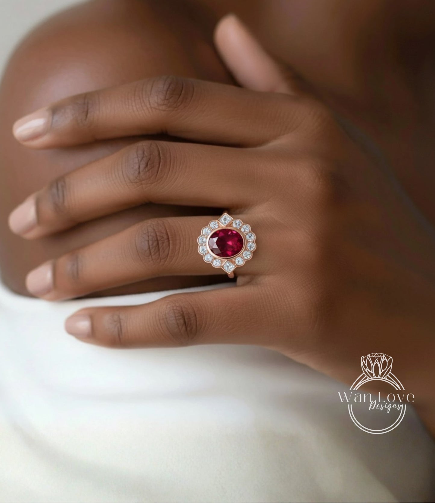 A close-up of a hand wearing a ring with a large red gemstone, likely a ruby, surrounded by smaller diamonds.