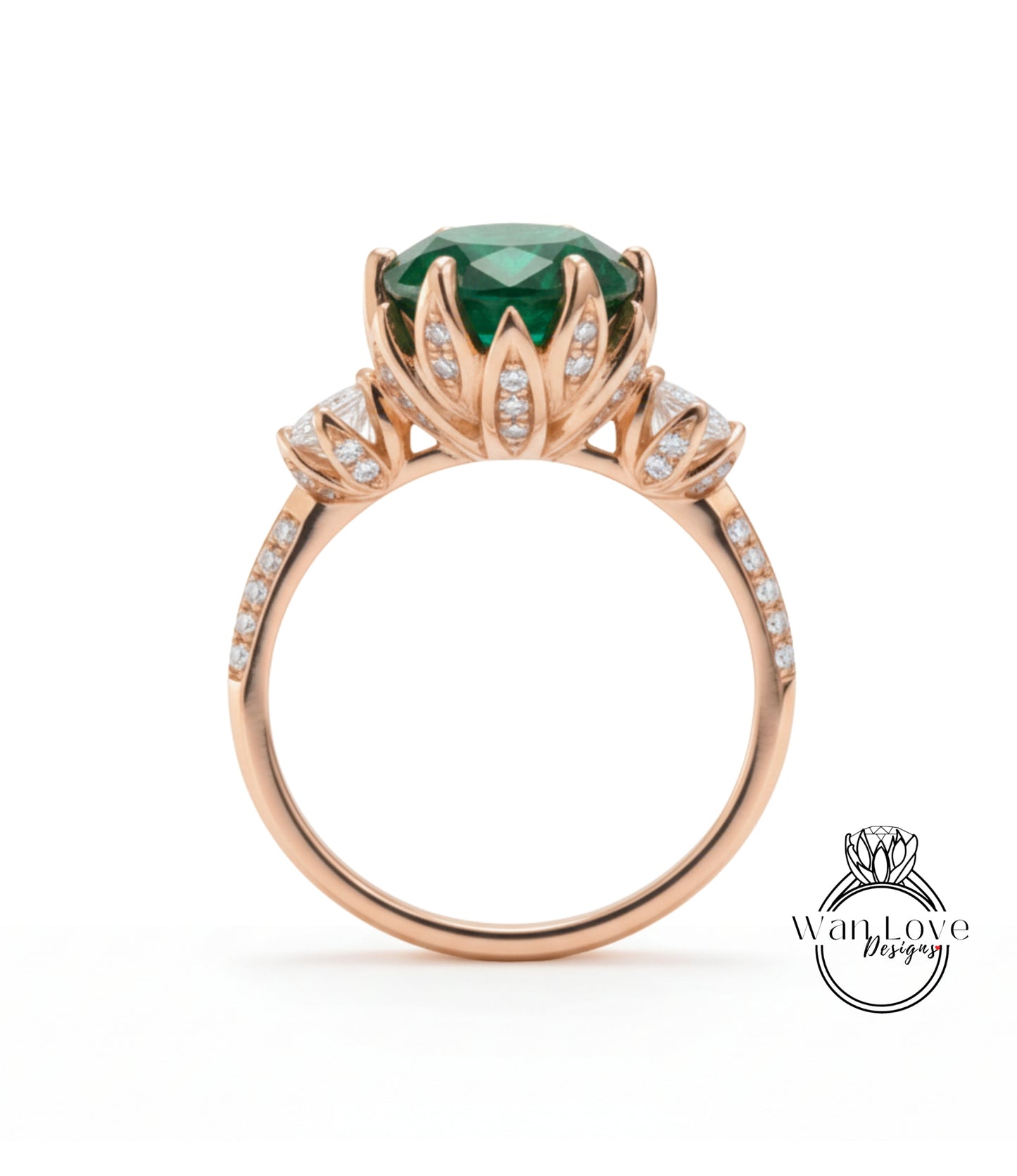 A gold ring with a large green gemstone, surrounded by smaller diamonds, and a flower-like design on the band.
