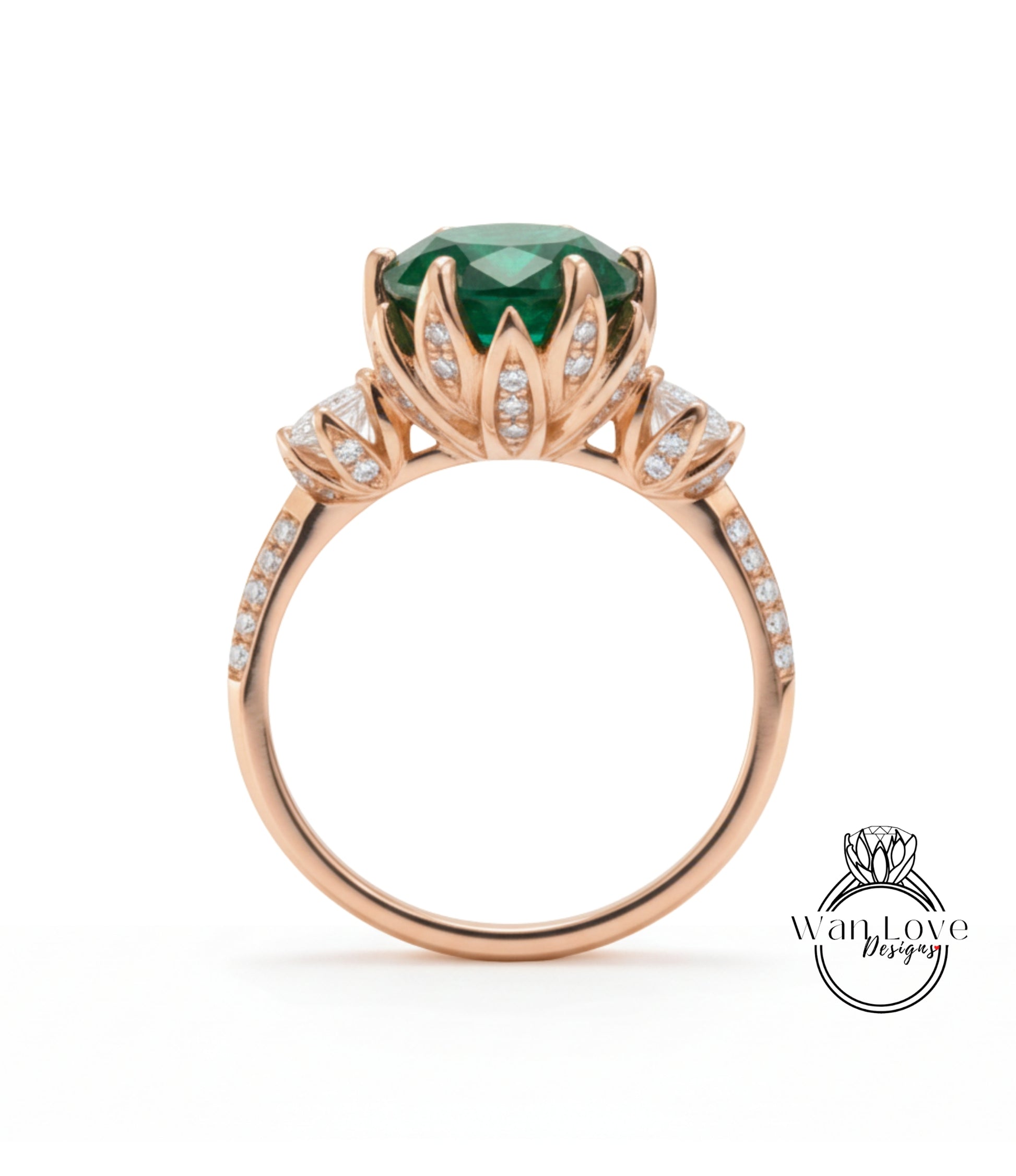 A gold ring with a large green gemstone, surrounded by smaller diamonds, and a flower-like design on the band.