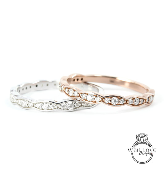 Two rings with diamonds on them are displayed against a white background.