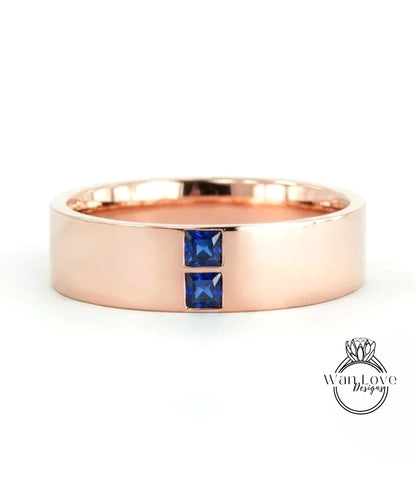 A rose gold ring with a large central gemstone and two smaller gemstones on either side.