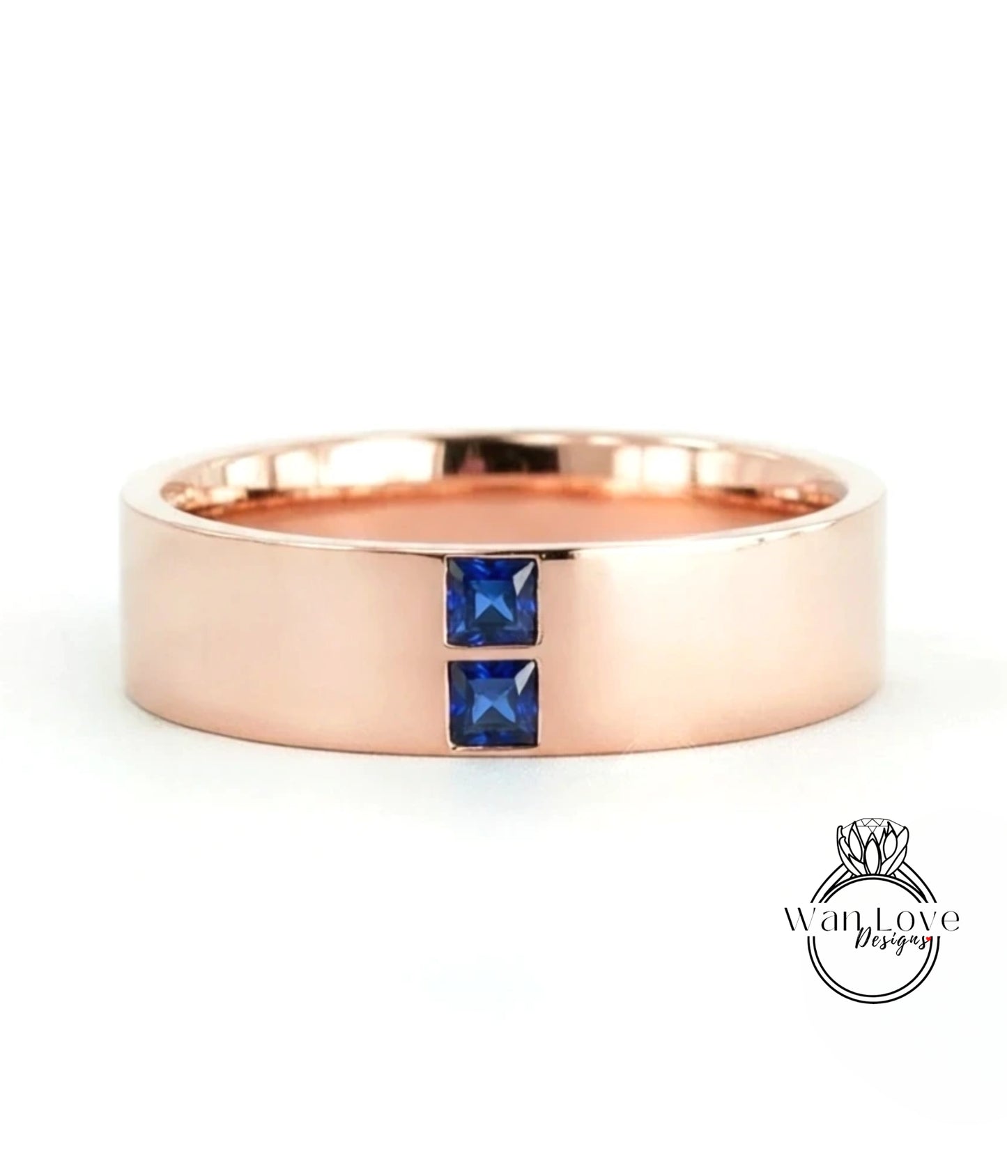 A rose gold ring with a large central gemstone and two smaller gemstones on either side.