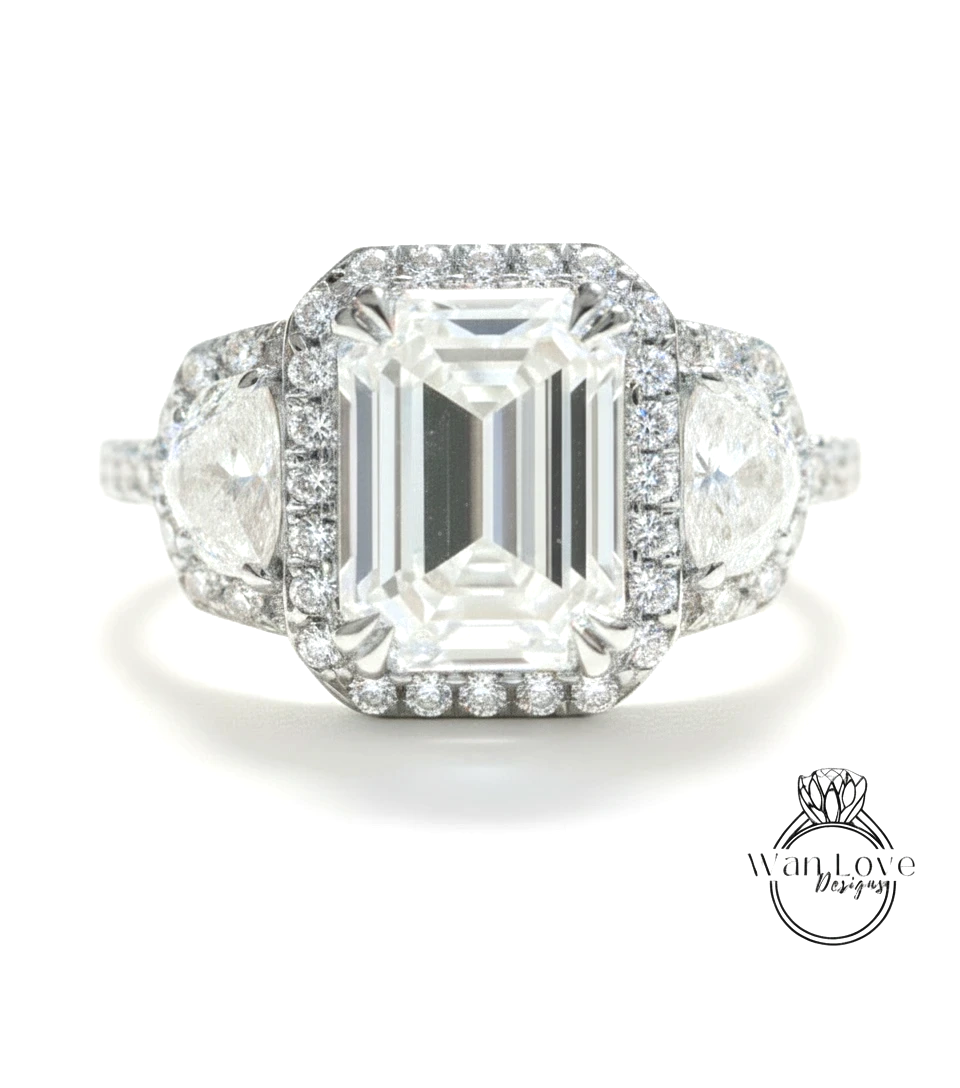 A stunning diamond engagement ring with a large central diamond surrounded by smaller diamonds on either side, set in a halo of smaller diamonds.