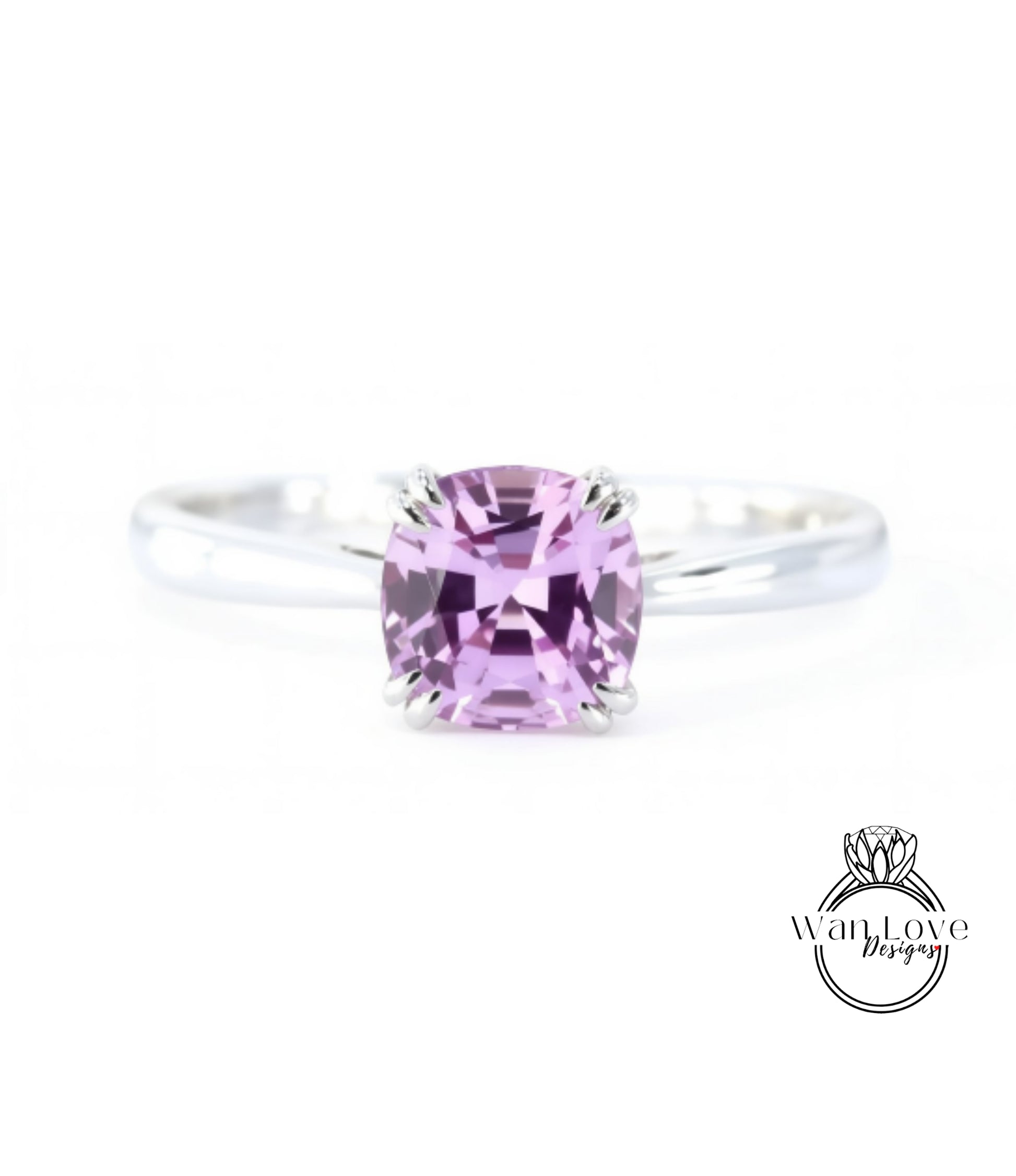 A close-up image of a silver ring with a large, clear, and vibrant purple gemstone, which appears to be a sapphire.