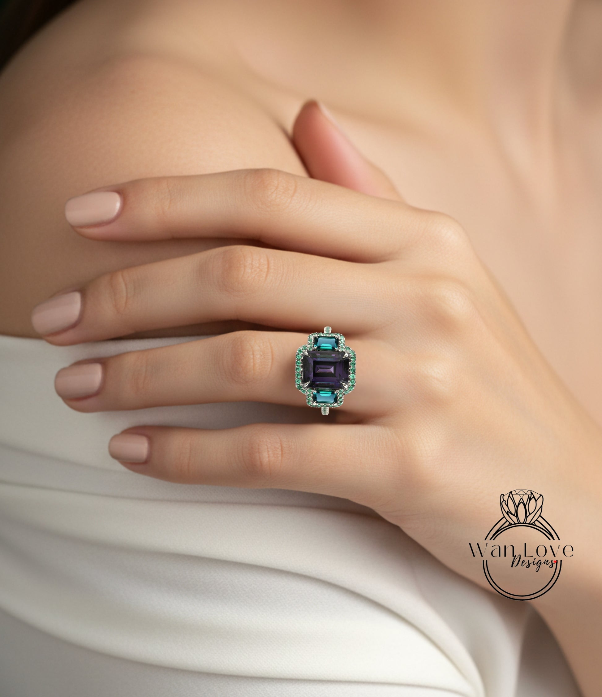 A close-up of a person's hand wearing a large, ornate ring with a blue and green gemstone.