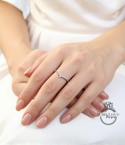 A close-up image of a person's hands wearing a diamond ring.