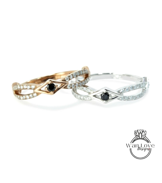 Two rings with diamonds and a black gemstone are displayed against a white background.