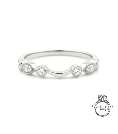 A silver ring with a curved band and a row of small diamonds set in the center.