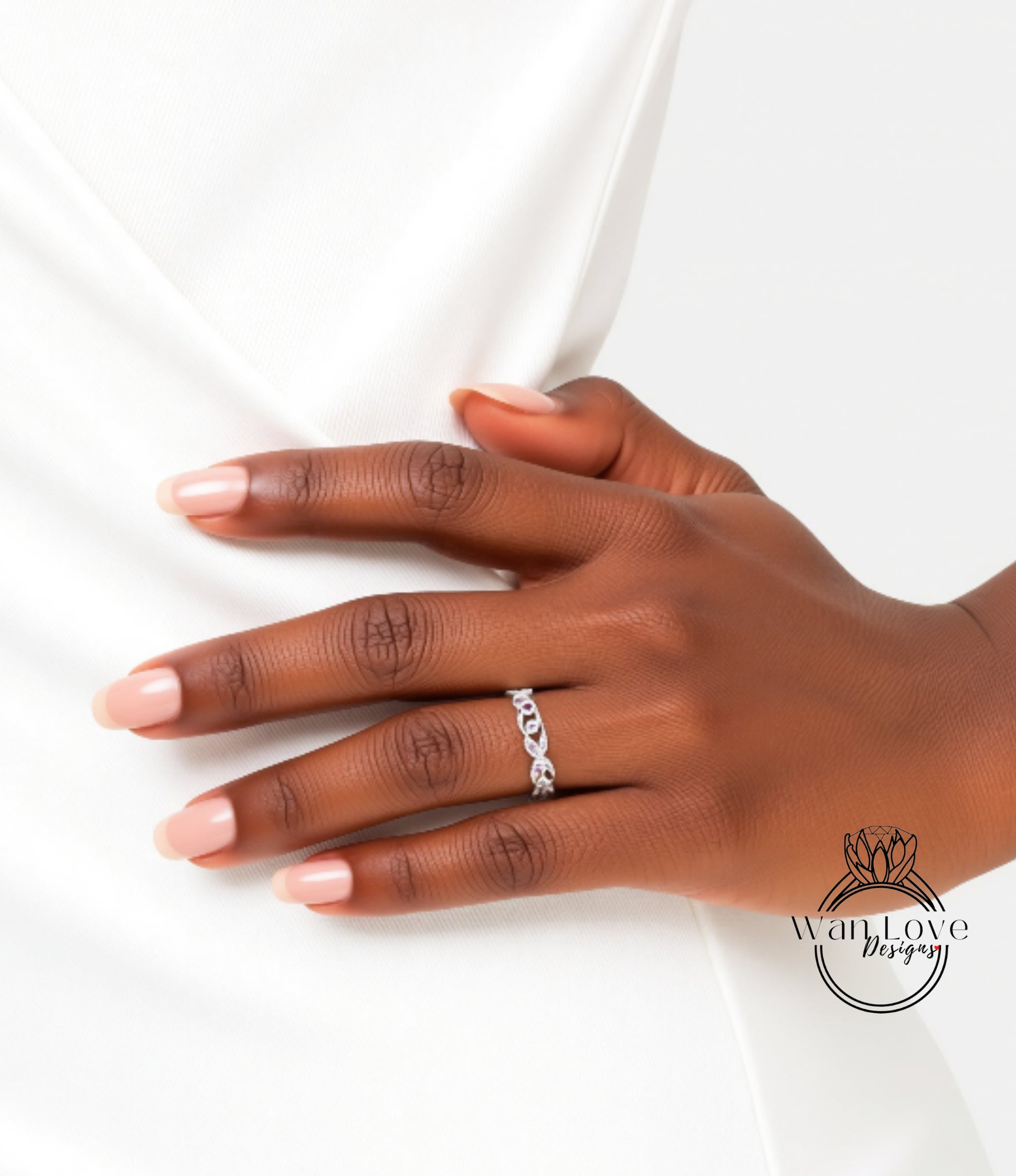 A close-up of a hand wearing a ring on the ring finger.