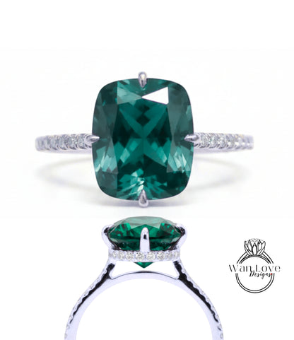 A large, green gemstone engagement ring with a silver band and small diamonds.
