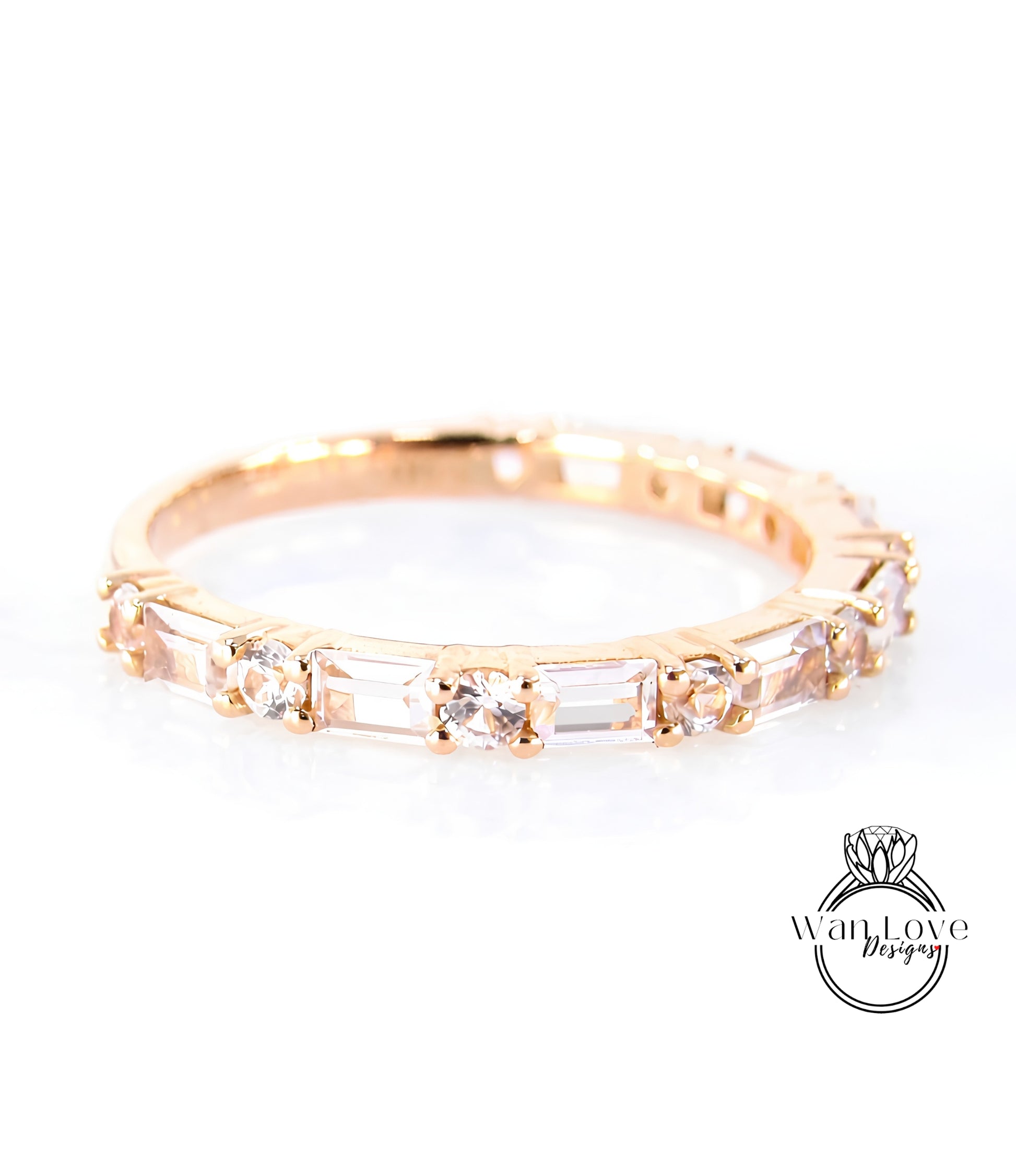 A gold ring with a row of clear gemstones, including diamonds, set in a thin band.