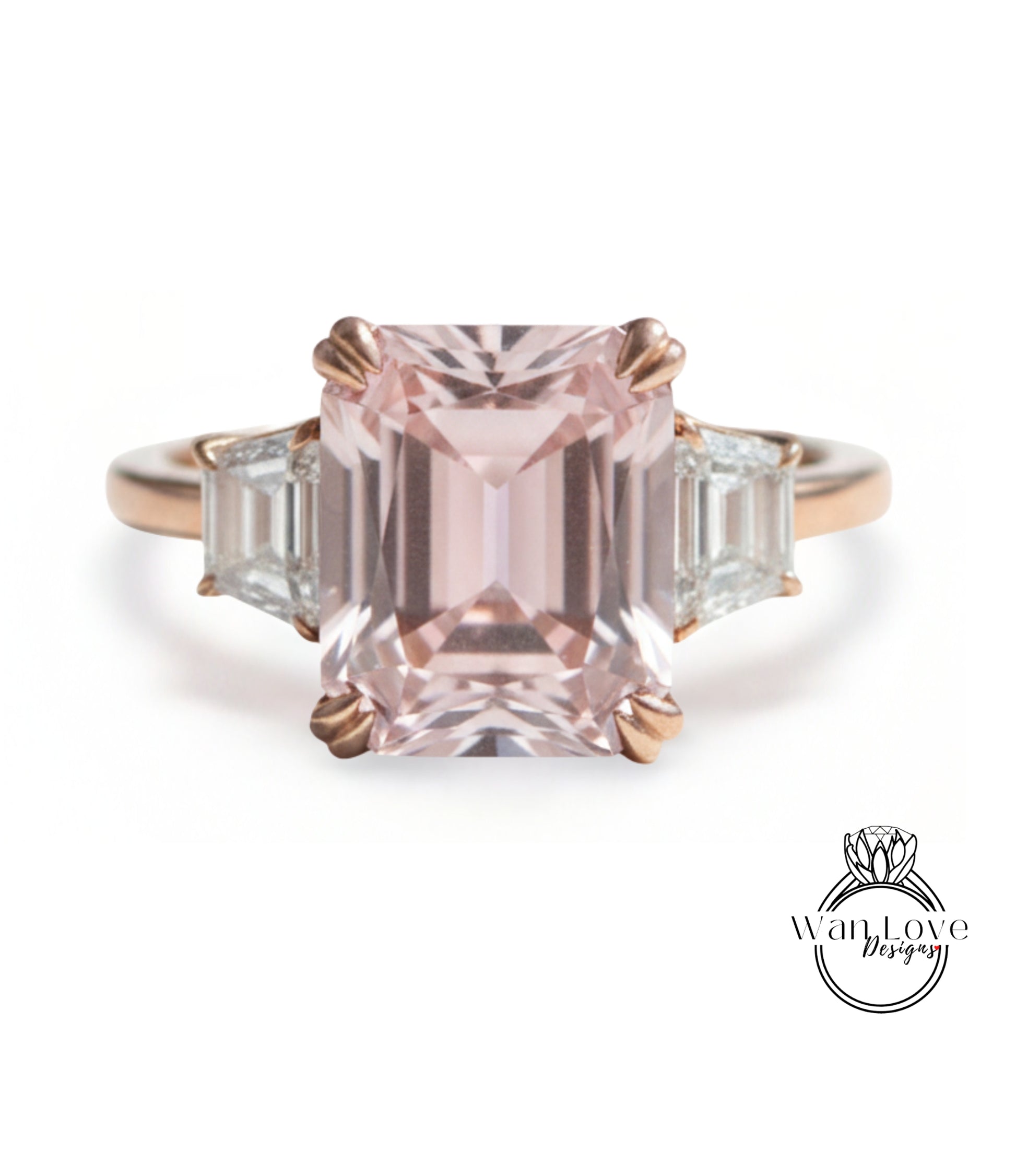 A pink gemstone engagement ring with a large central gemstone surrounded by smaller gemstones on either side.