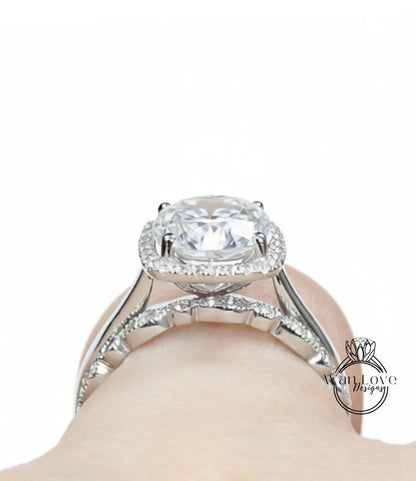 A close-up view of a diamond engagement ring on a person's hand, showcasing the large, clear gemstone set in a halo of smaller diamonds.