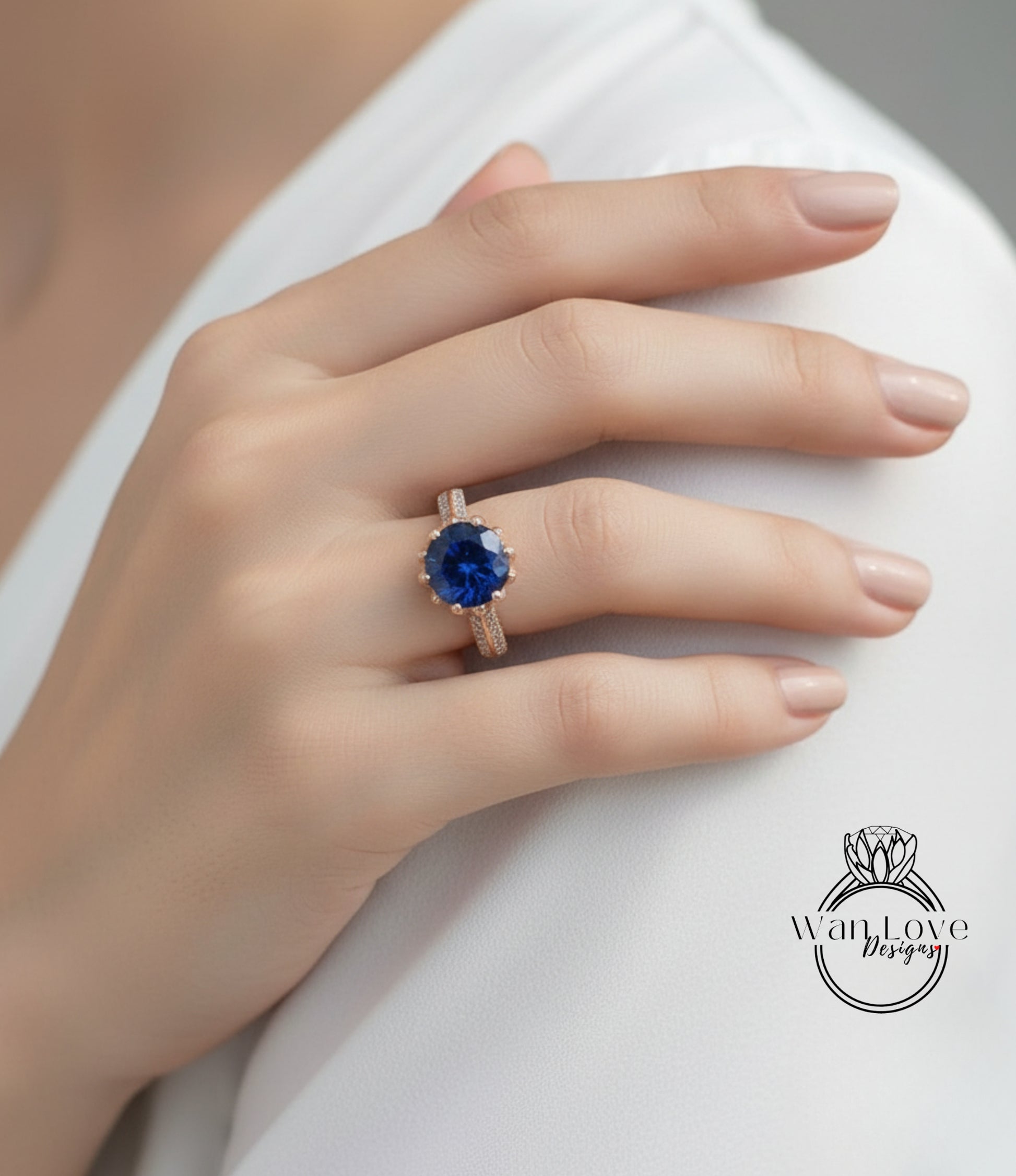 A close-up of a person's hand wearing a gold ring with a large blue gemstone.