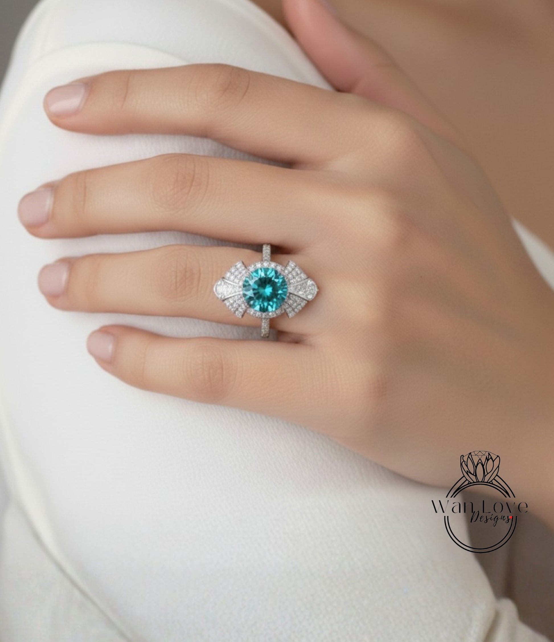 A close-up of a person's hand wearing a large, ornate ring with a blue gemstone.
