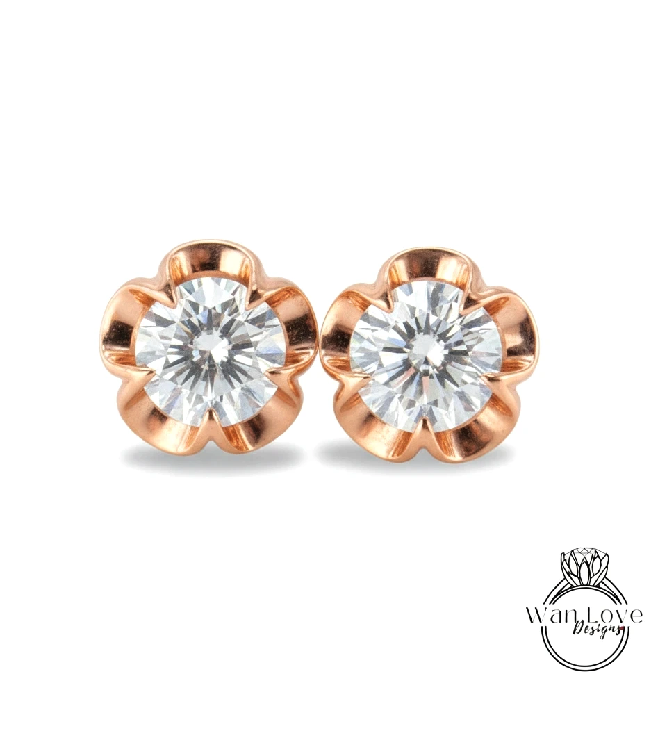 two diamond earrings with a rose gold design, set in a rose gold flower-shaped setting.
