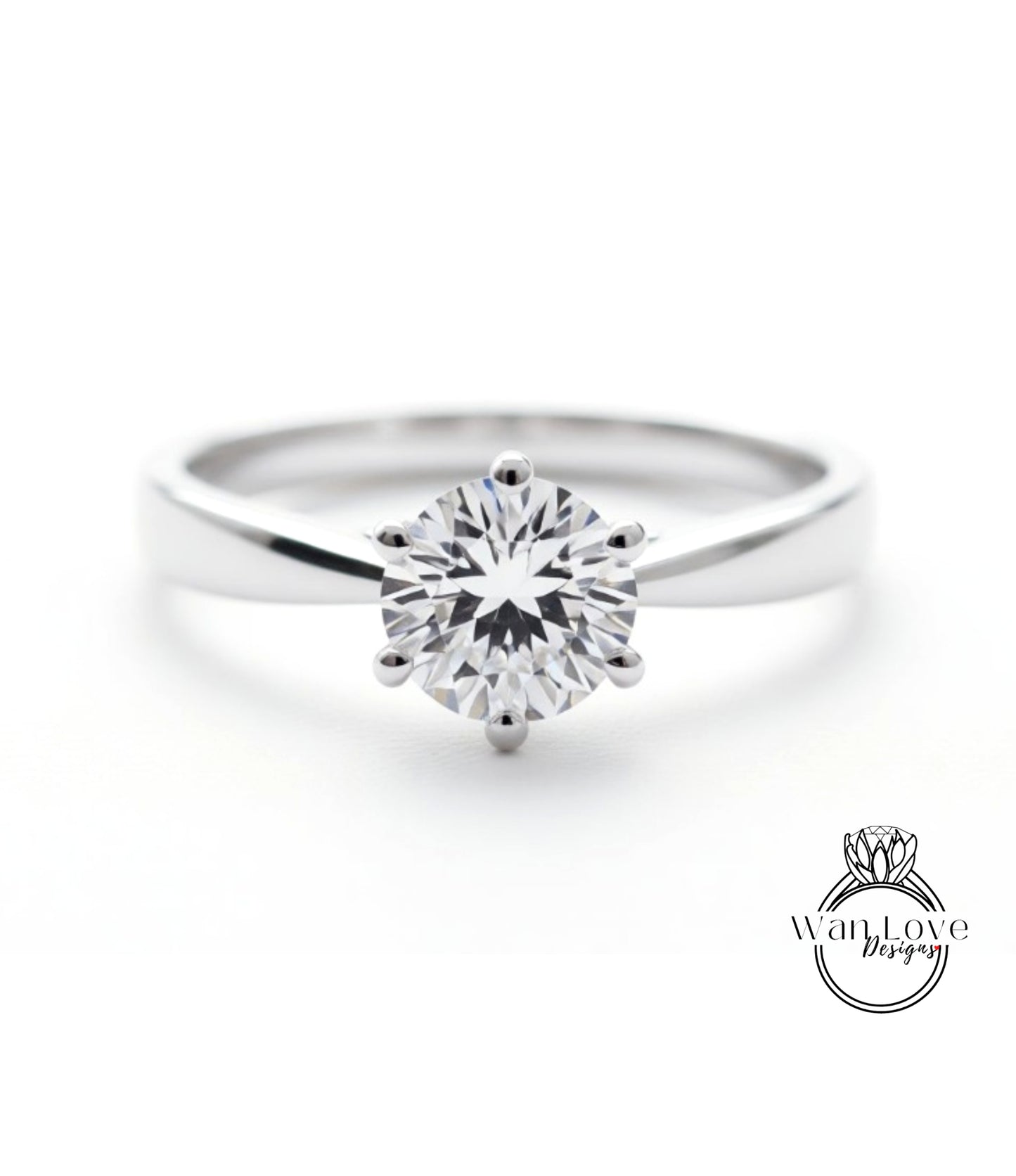 A close-up view of a diamond engagement ring with a large, brilliant-cut diamond set in a silver band.