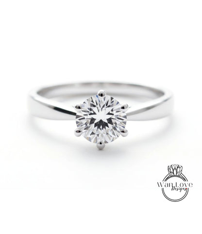 A close-up view of a diamond engagement ring with a large, brilliant-cut diamond set in a silver band.