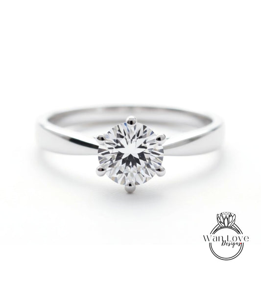 A close-up view of a diamond engagement ring with a large, brilliant-cut diamond set in a silver band.