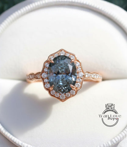 A close-up image of a gold ring with a large oval-shaped blue gemstone set in the center, surrounded by smaller diamonds.