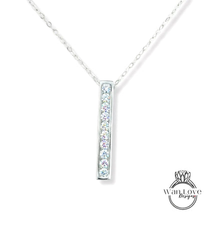 A silver necklace with a rectangular pendant featuring a row of small diamonds.