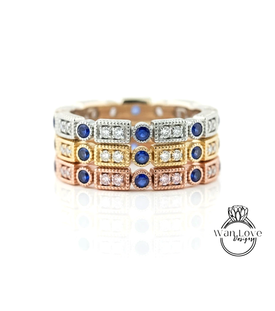A ring with multiple layers of rings, each with a blue gemstone and a small diamond. The rings are arranged in a circular pattern, creating a visually appealing design.