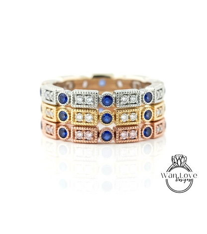 A ring with multiple layers of rings, each with a blue gemstone and a small diamond. The rings are arranged in a circular pattern, creating a visually appealing design.