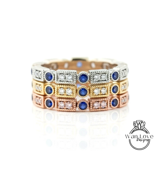 A ring with multiple layers of rings, each with a blue gemstone and a small diamond. The rings are arranged in a circular pattern, creating a visually appealing design.