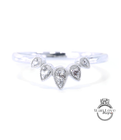 A silver ring with a unique design featuring a central diamond surrounded by smaller diamonds arranged in a fan-like pattern.