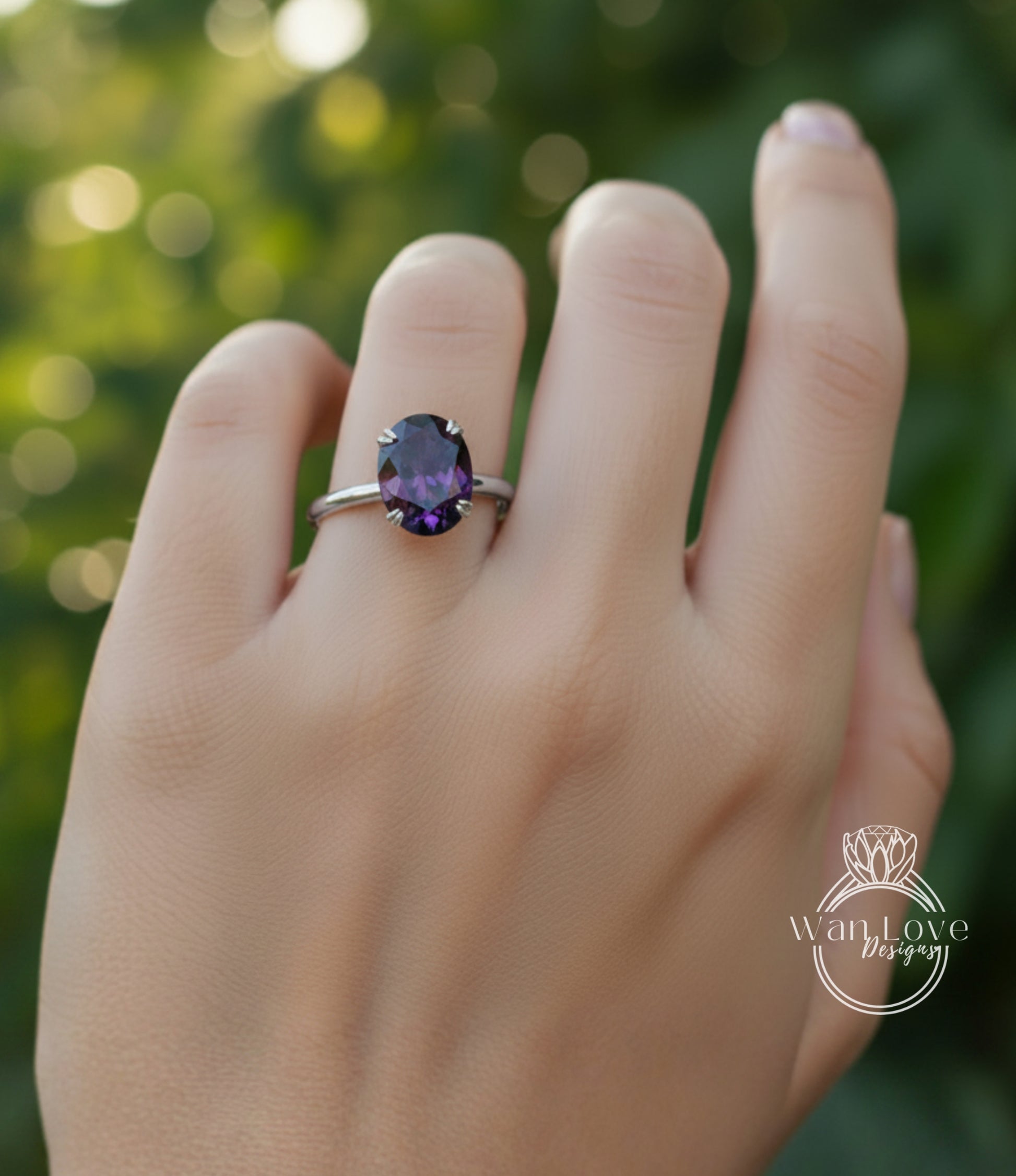 A close-up of a hand wearing a ring with a large purple gemstone, set in a silver band.