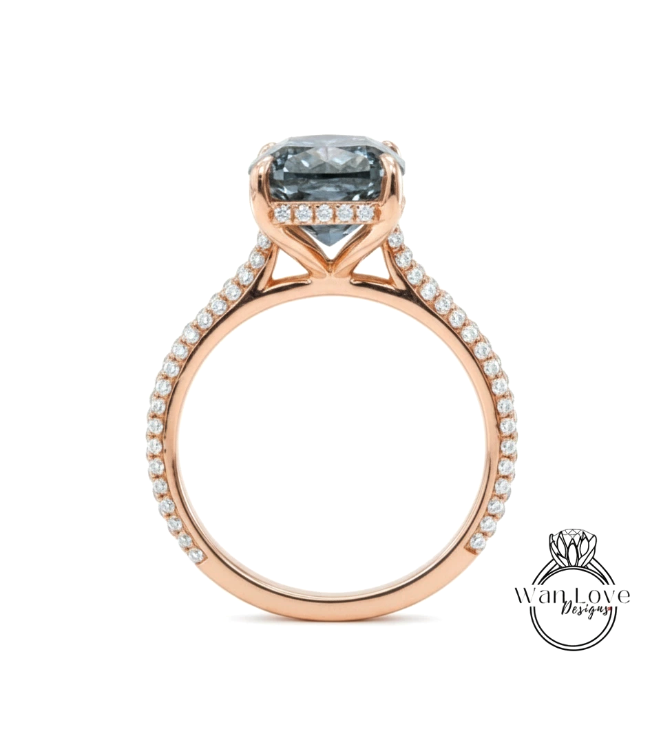 A rose gold engagement ring with a large blue gemstone set in the center, surrounded by smaller diamonds.