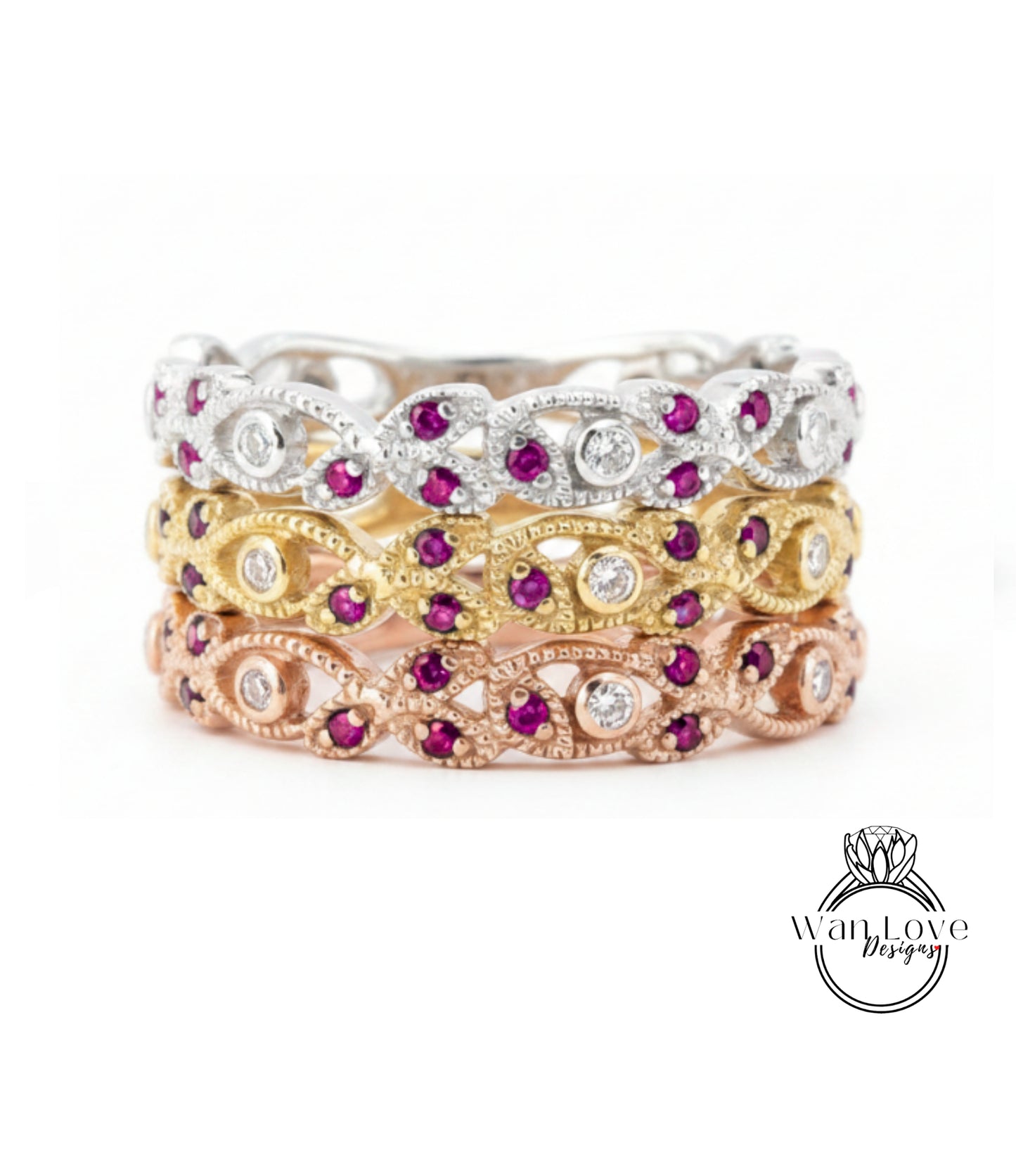 A stack of three rings with various gemstones, including diamonds and rubies, set in different colored metals.